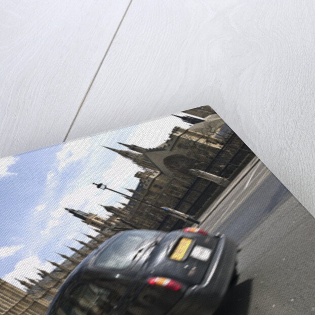 Taxi on road with big ben in background, London by Assaf Frank